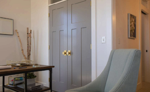 gray double doors in house with blue chair and table in front of it